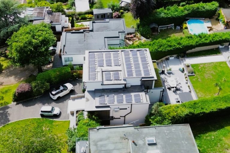 33 Solar panels mounted on a flat roofed residential property