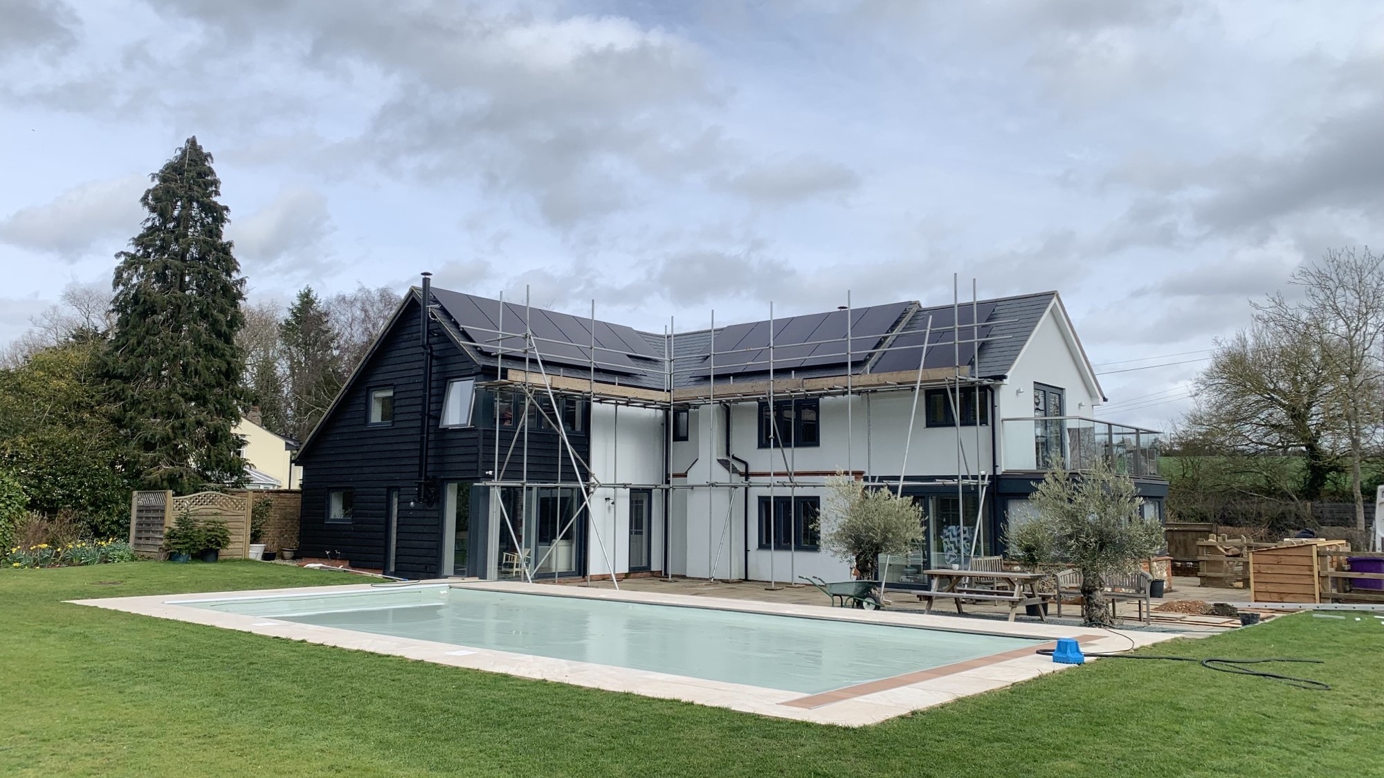 Full black solar panel installation. Roof mounted on a beautiful modern countryside home