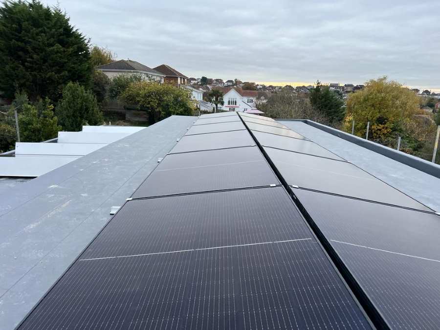 Solar panel array mounted on a flat roof using metal frames