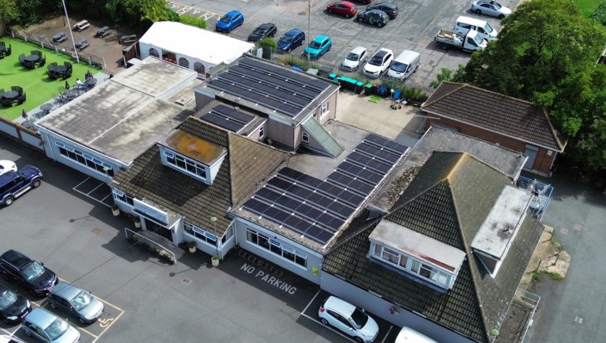 Drone photo of solar panels installed onto flat roof of local conservative club