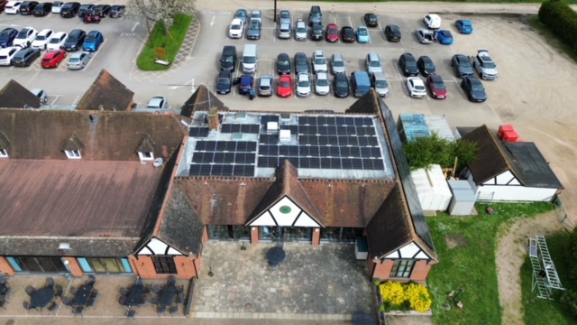 Drone photo of solar panel installation on a local golf club. 142 Solar Panels fitted to a flat roof with pitched mounting system