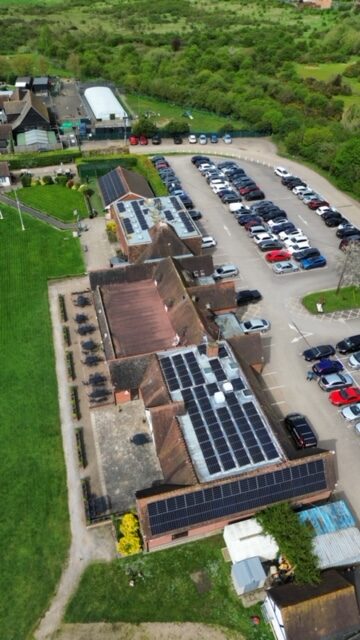 Drone photo of solar panel installation on a local golf club. 142 Solar Panels fitted to a flat roof with pitched mounting system