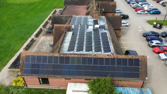 Drone photo of solar panel installation on a local golf club. 142 Solar Panels fitted to a flat roof with pitched mounting system