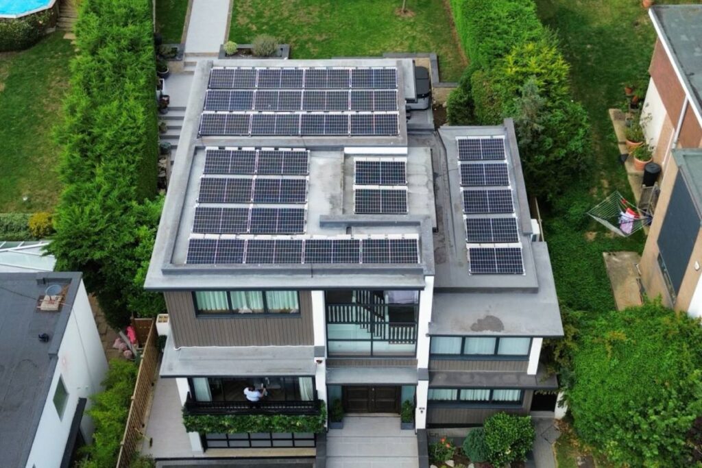 Drone photograph of 33 Solar Panels mounted on a residential flat roof.
