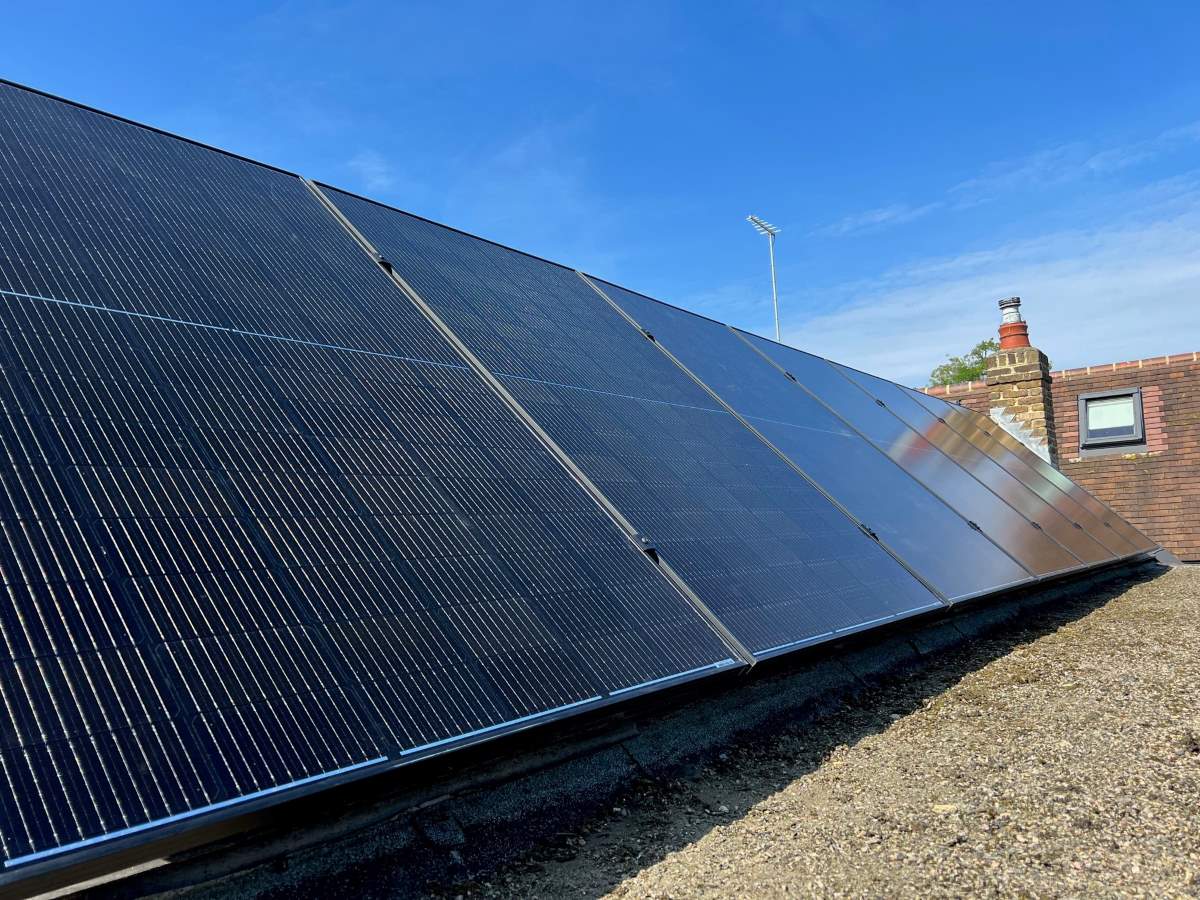 Solar panel system mounted to the flat roof of an outbuilding