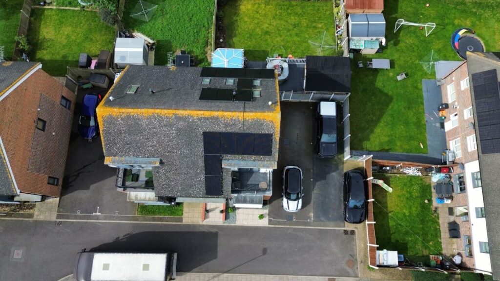 Drone photo of residential full black solar panels on a pitched roof