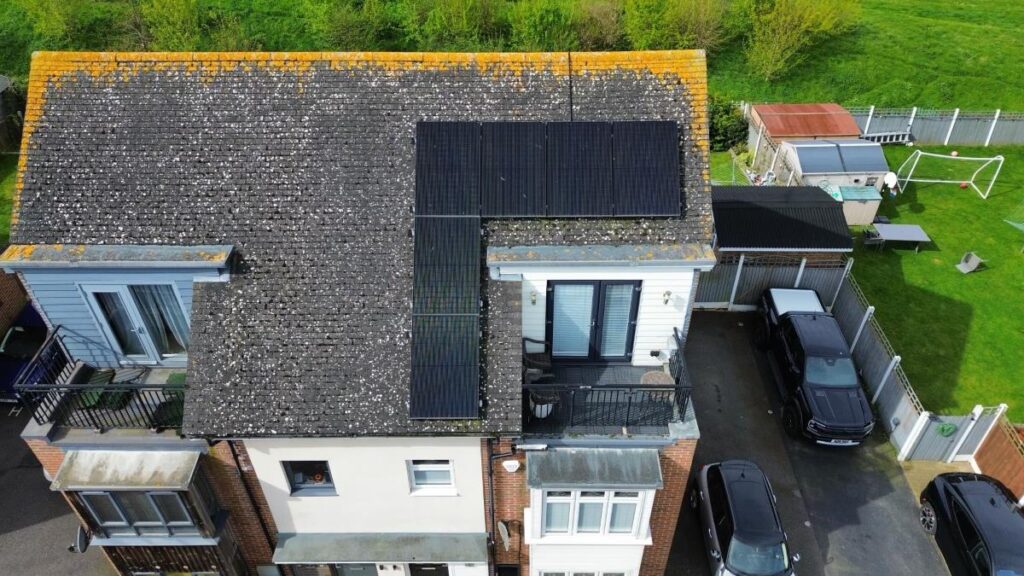 Drone photo of residential full black solar panels on a pitched roof