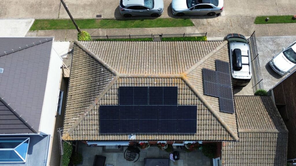 Drone photograph of roof mounted solar panels on a house.