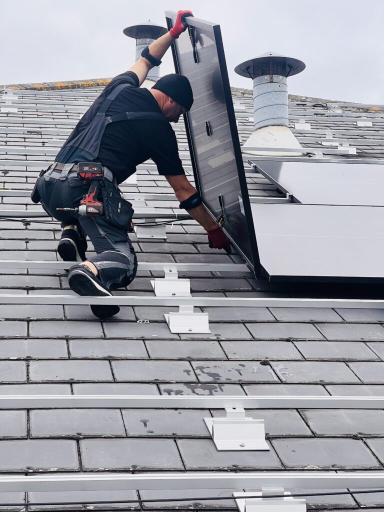 A SolarTherm UK installer fitting one of over 400 panels to this industrial building in Berkshire.