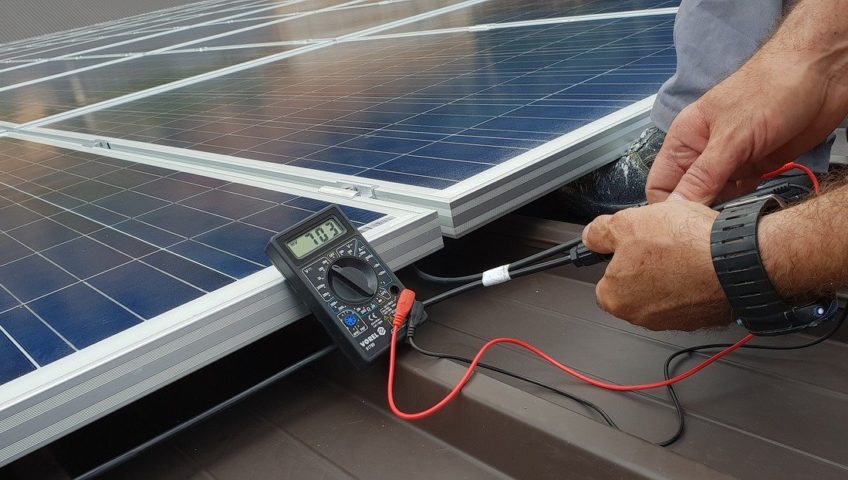Technician testing a solar panel