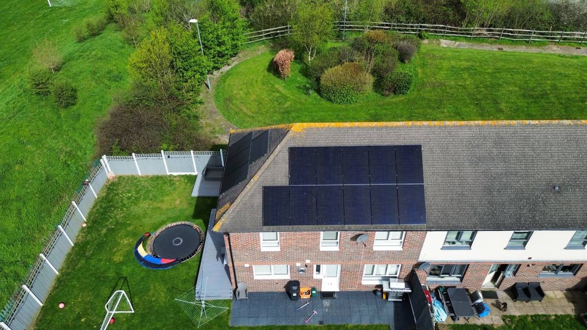 Drone image of full-black Amerisolar solar panels fitted to semi-detached home