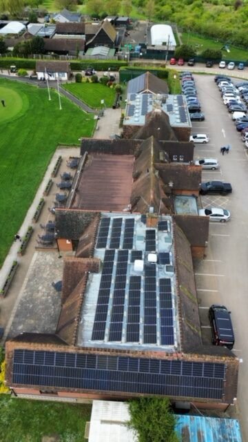 Drone photo of solar panel installation on a local golf club. 142 Solar Panels fitted to a flat roof with pitched mounting system
