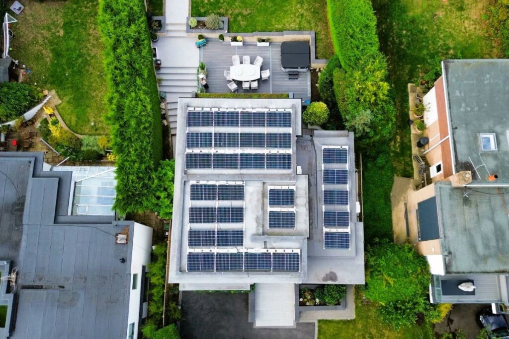 Drone photograph of 33 Solar Panels mounted on a residential flat roof.