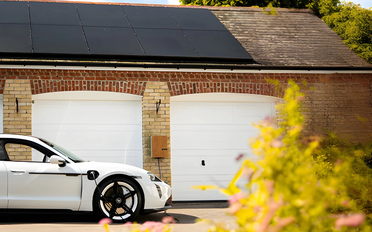 EV Charging on wall mounted charger on home with solar panels