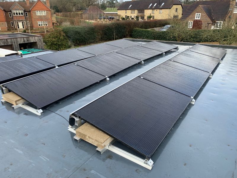 Solar panels on a flat roof, secured with ballasted metal mounting frames