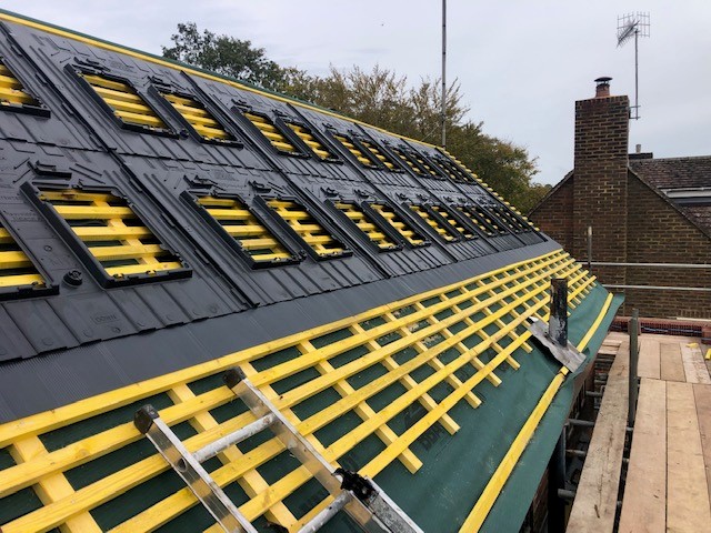 Roof-integrated solar panel mounting trays fitted to the roof structure.