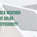 Solar panels installed on a pitched roof that is covered in snow